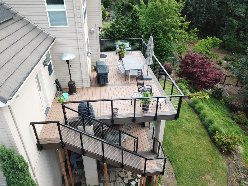 Two story Trex deck with cable rail and cedar ceiling | Deck Masters, LLC