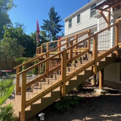 Cedar railing with black hog panel infill