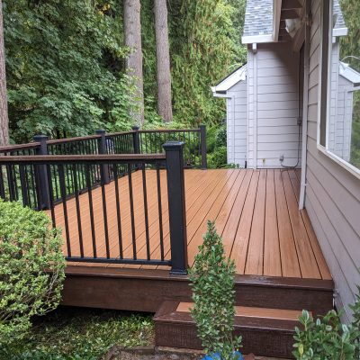 Trex deck with Tiki torch and lava rock decking plus cocktail railing.
