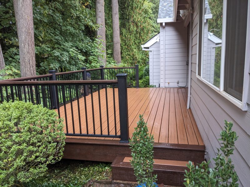 Trex deck with tiki torch and lava rock decking plus a cocktail rail ...